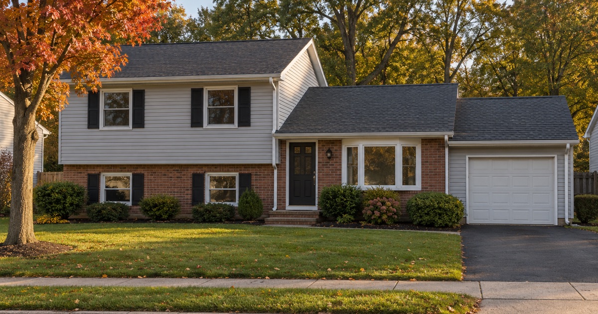 A finished new roof on an Old Bridge Township split-level in evening light, gutters and trim complete.